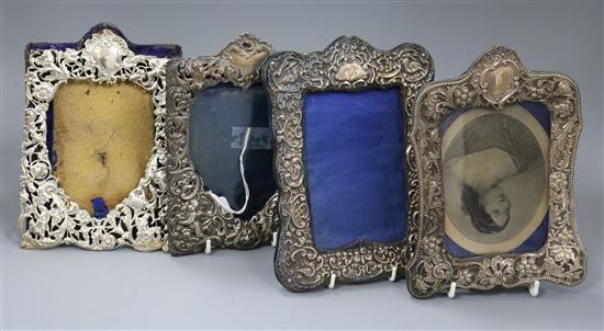 Four assorted late 19th/early 20th century repousse silver mounted photograph frames.